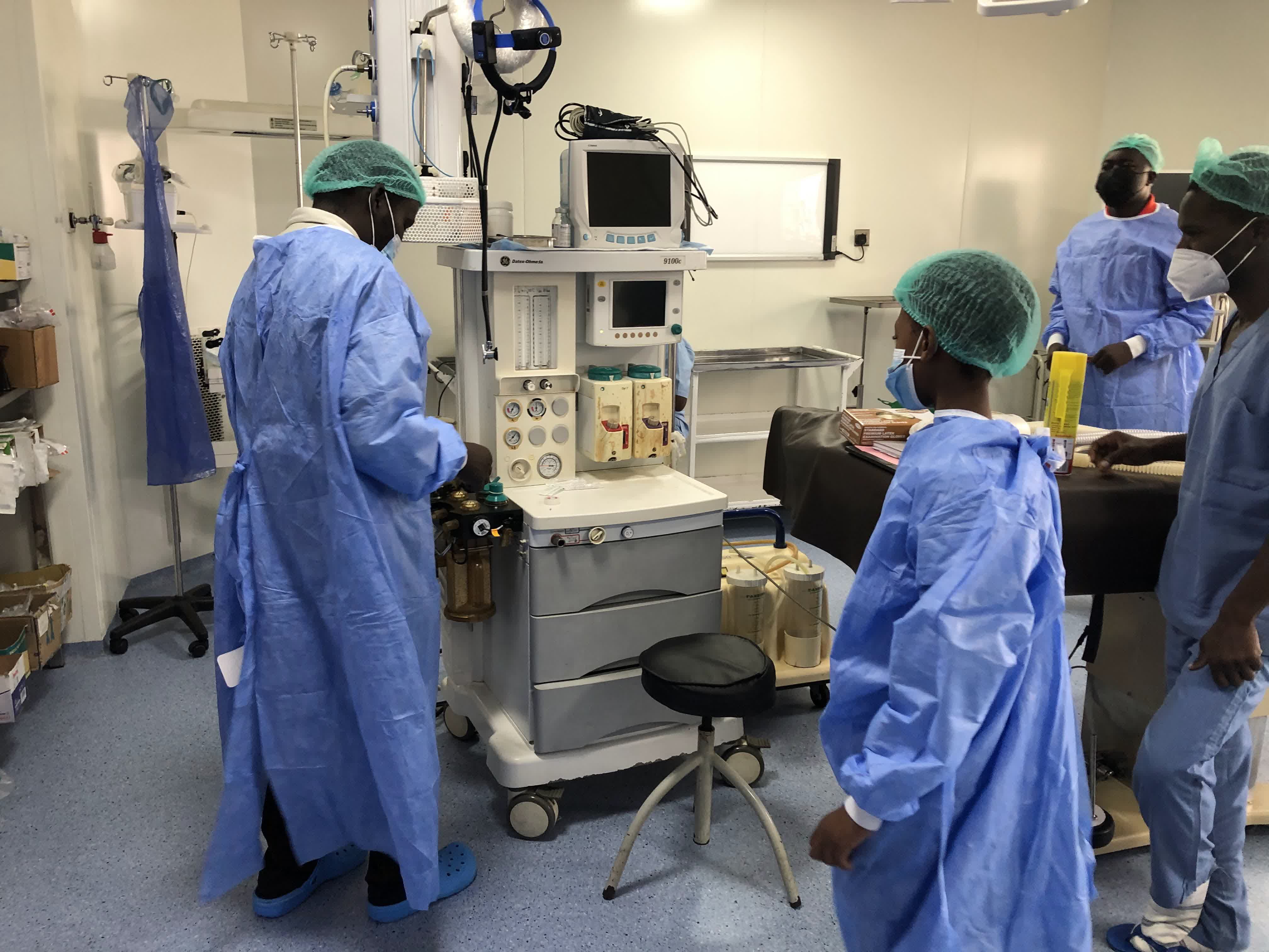 Surgical team using a donated anaesthesia machine in an operating room
